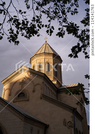 The Kashveti Church of St. George in central Tbilisi, located across from the Parliament building on Rustaveli Avenue. Dramatic light on dark clouds background. The Kashveti Church of St. George in central Tbilisi, located across from the Parliament building on Rustaveli Avenue. Dramatic light on dark clouds background. 114141763