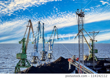Portal harbour cranes ready to unload coal at port. Portal harbour cranes ready to unload coal at port. 114142112