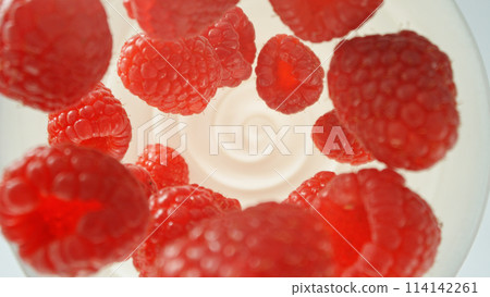 Fresh raspberries falling into yoghurt cream, top down view 114142261