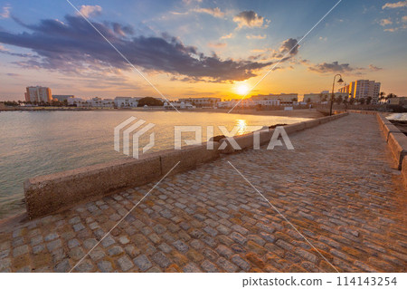 Breakwater bridge from Fort San Sebastian to the shore at dawn. 114143254