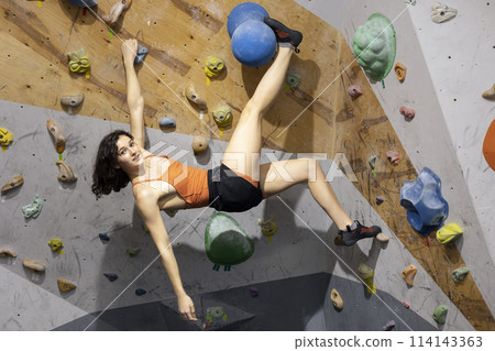 girl climbing up the wall 114143363