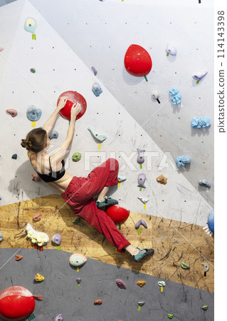 girl climbing up the wall girl climbing up the wall 114143398
