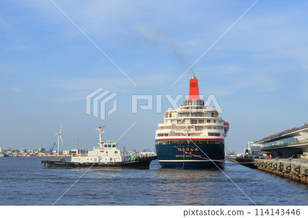 Luxury cruise ship approaching the pier; a cruise ship being pushed by a tugboat Luxury cruise ship approaching the pier; a cruise ship being pushed by a tugboat 114143446