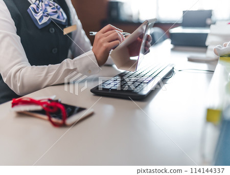 Female employees working at a company 114144337