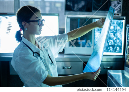Medical female specialist checkup analytics x-ray film scan examining in laboratory at hospital. Medical female specialist checkup analytics x-ray film scan examining in laboratory at hospital. 114144394