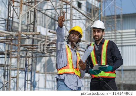 Construction civil engineer man and woman African American checking quality of work 114144962
