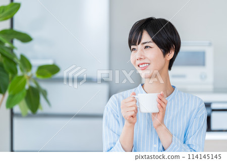 A woman relaxing in the living room. A woman relaxing in the living room. 114145145