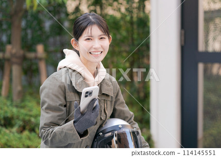 Female rider with smartphone 114145551