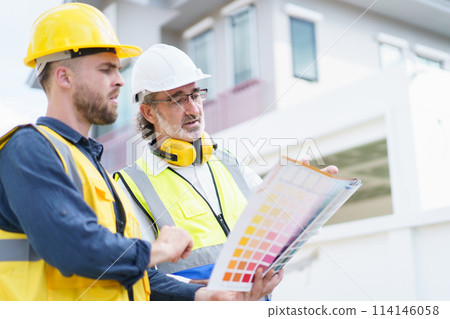 Engineers or construction contractors discussing together at the empty land about construction plan. Man talking to real estate contractor on building blueprint. 114146058