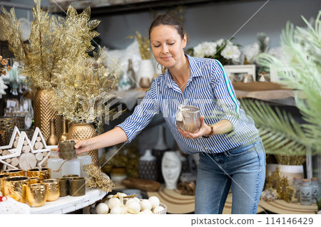 Festive woman choosing christmas candles 114146429