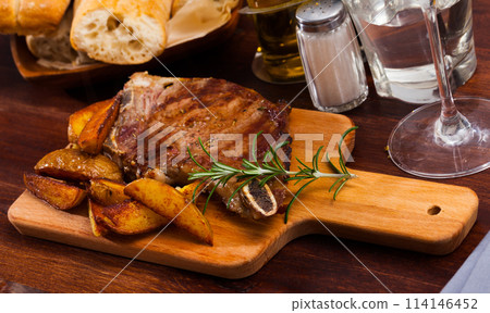 Appetizing beef steak with potatoes and rosemary Appetizing beef steak with potatoes and rosemary 114146452