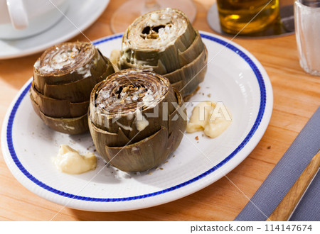 Plate of tasty steamed artichoke 114147674