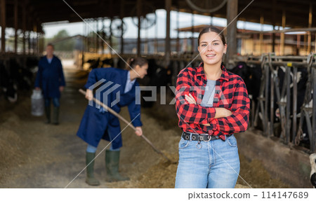 Portrait of female farm owner in cowshed 114147689