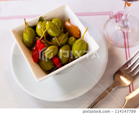 Green olives served with pepper and garlic 114147789