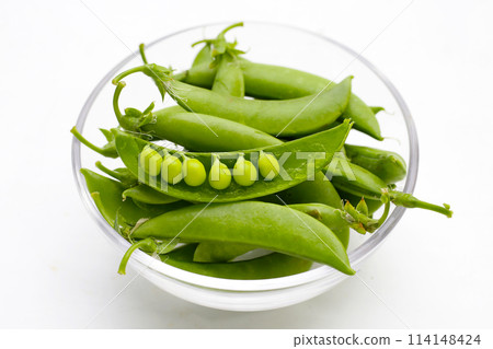 Fresh young green peas on white background. Fresh young green peas on white background. 114148424
