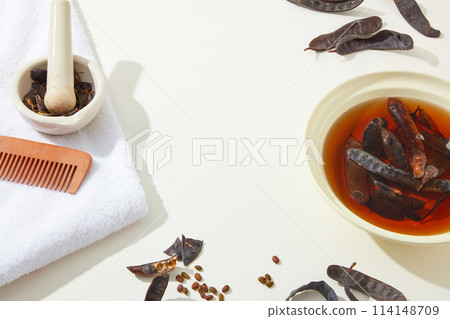 High angle view at a group of ingredients for producing cosmetic made from locust, a round bowl of locust liquid. Blank space for advertising and designing High angle view at a group of ingredients for producing cosmetic made from locust, a round bowl of locust liquid. Blank space for advertising and designing 114148709