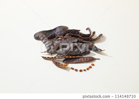 A pile of black locust pods isolated on white background from high angle shot. Vacant space for displaying product made from black locust, copy space A pile of black locust pods isolated on white background from high angle shot. Vacant space for displaying product made from black locust, copy space 114148710
