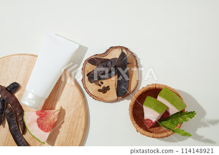 Flat lay natural compositions of cosmetic producing over white table, a white tube without label. Blank space for advertising and designing Flat lay natural compositions of cosmetic producing over white table, a white tube without label. Blank space for advertising and designing 114148921