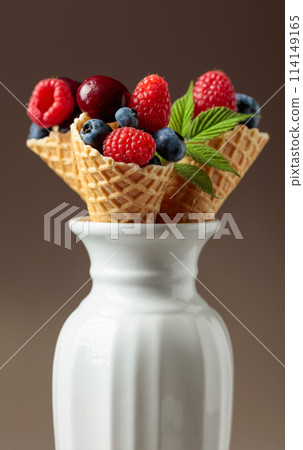 Fresh berries in waffle cones. 114149165