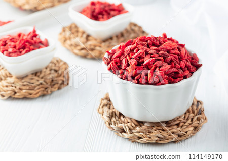 Dried goji berries on a white table. Dried goji berries on a white table. 114149170