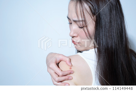 Image of a woman suffering from back acne Image of a woman suffering from back acne 114149448