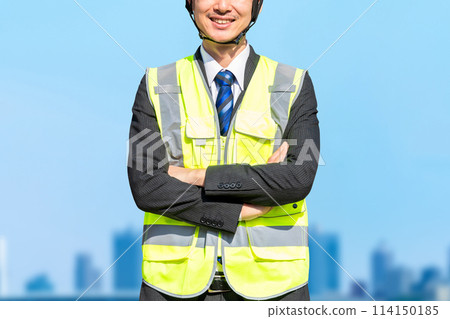 A male site supervisor wearing a helmet (construction work) A male site supervisor wearing a helmet (construction work) 114150185