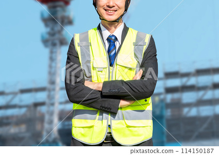 A male site supervisor wearing a helmet (construction work) A male site supervisor wearing a helmet (construction work) 114150187