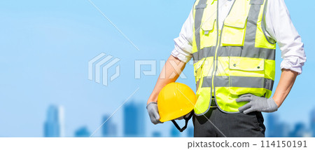 A male site supervisor standing with a helmet (construction work) A male site supervisor standing with a helmet (construction work) 114150191