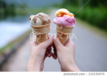 Closed up woman hand holding couple Waffle strawberry and chocolate Ice Cream Closed up woman hand holding couple Waffle strawberry and chocolate Ice Cream 114150474