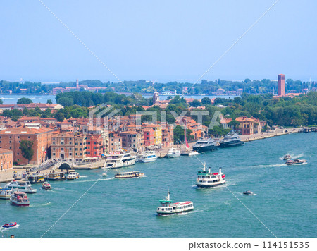 A view of the red-tiled roof buildings and the harbor from a high vantage point (from the Bell Tower of St. Mark's Basilica, Venice, Italy) 114151535