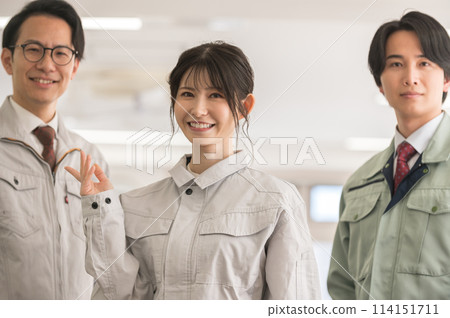 Three male and female engineers in work clothes Three male and female engineers in work clothes 114151711