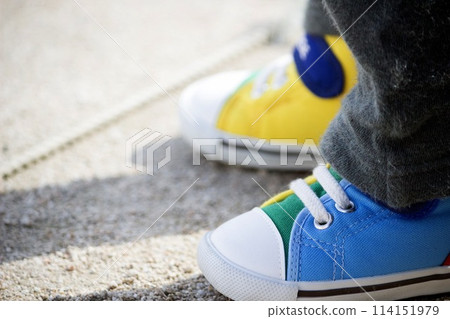 Children's feet wearing shoes in the park Children's feet wearing shoes in the park 114151979