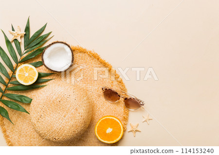 Top view of various seashells placed near colorful fruit and stylish summer accessories on table background. Summer concept. Flat lay. Top view with copy space for text Top view of various seashells placed near colorful fruit and stylish summer accessories on table background. Summer concept. Flat lay. Top view with copy space for text 114153240