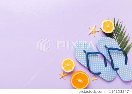 Top view composition of flip flops placed with beach accessories top view on table background. Tropical summer vacation concept Flat lay Top view composition of flip flops placed with beach accessories top view on table background. Tropical summer vacation concept Flat lay 114153247