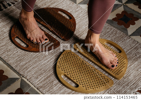 Pair of wooden sadhu boards contrasting with patterned and plain mats 114153465