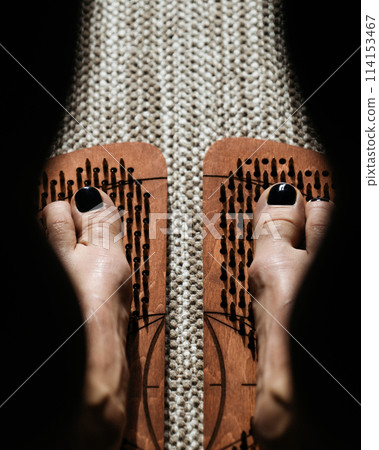 Shadow and light play over wooden acupressure boards with protruding pegs 114153467