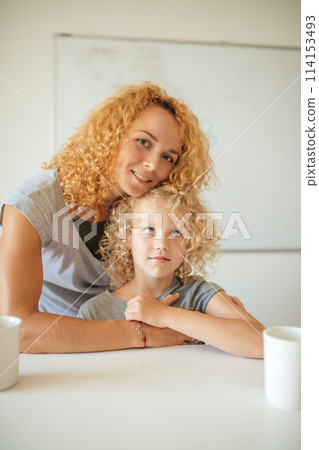 Smiling Mother and her adorable daughter looking at camera. 114153493