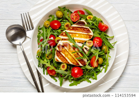salad with grilled halloumi greek cheese in bowl 114153594