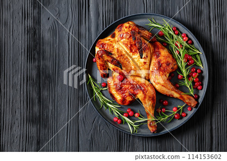 butterflied, spatchcock roast chicken on a plate 114153602