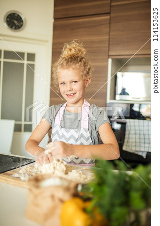 little girl kneading dough, baking cookies for christmas little girl kneading dough, baking cookies for christmas 114153625