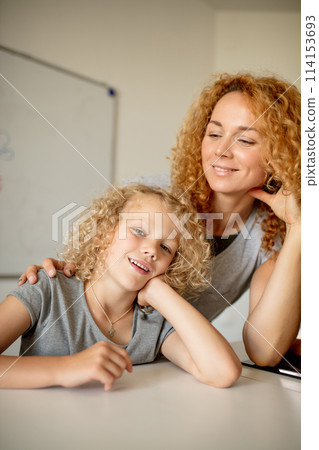 Smiling Mother and her adorable daughter looking at camera. 114153693