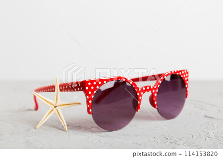 sunglasses with seashell lying on table background. Sunglasses on summer background. Top view flat lay with copy space for text sunglasses with seashell lying on table background. Sunglasses on summer background. Top view flat lay with copy space for text 114153820