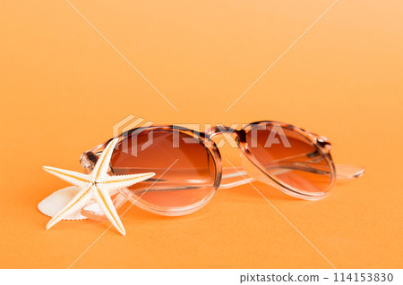 sunglasses with seashell lying on table background. Sunglasses on summer background. Top view flat lay with copy space for text sunglasses with seashell lying on table background. Sunglasses on summer background. Top view flat lay with copy space for text 114153830