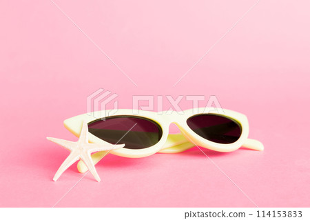 sunglasses with seashell lying on table background. Sunglasses on summer background. Top view flat lay with copy space for text sunglasses with seashell lying on table background. Sunglasses on summer background. Top view flat lay with copy space for text 114153833