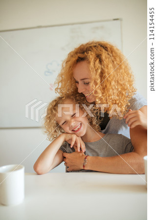 Smiling Mother and her adorable daughter looking at camera. 114154455