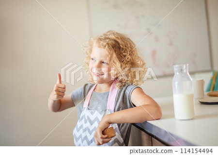 Cute little girl with glass of milk on color background Cute little girl with glass of milk on color background 114154494