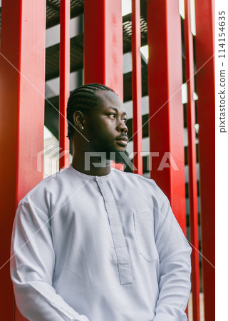 Cheerful male tourist portrait dress in white wear dashiki ethnic smiling at city street or small town background. African American travel model have free time. Millennial generation and gen z people Cheerful male tourist portrait dress in white wear dashiki ethnic smiling at city street or small town background. African American travel model have free time. Millennial generation and gen z people 114154635