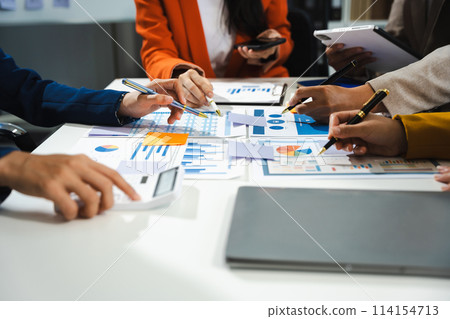 Business, technology and office concept - business team with laptop, tablet pc computer and papers having discussion in modern office. Business, technology and office concept - business team with laptop, tablet pc computer and papers having discussion in modern office. 114154713