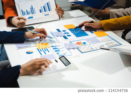 Business, technology and office concept - business team with laptop, tablet pc computer and papers having discussion in modern office. 114154736