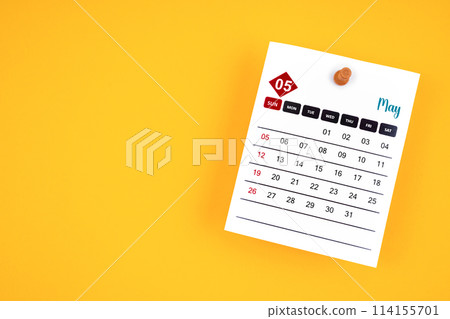 May 2024 calendar page with push pin on yellow background. May 2024 calendar page with push pin on yellow background. 114155701